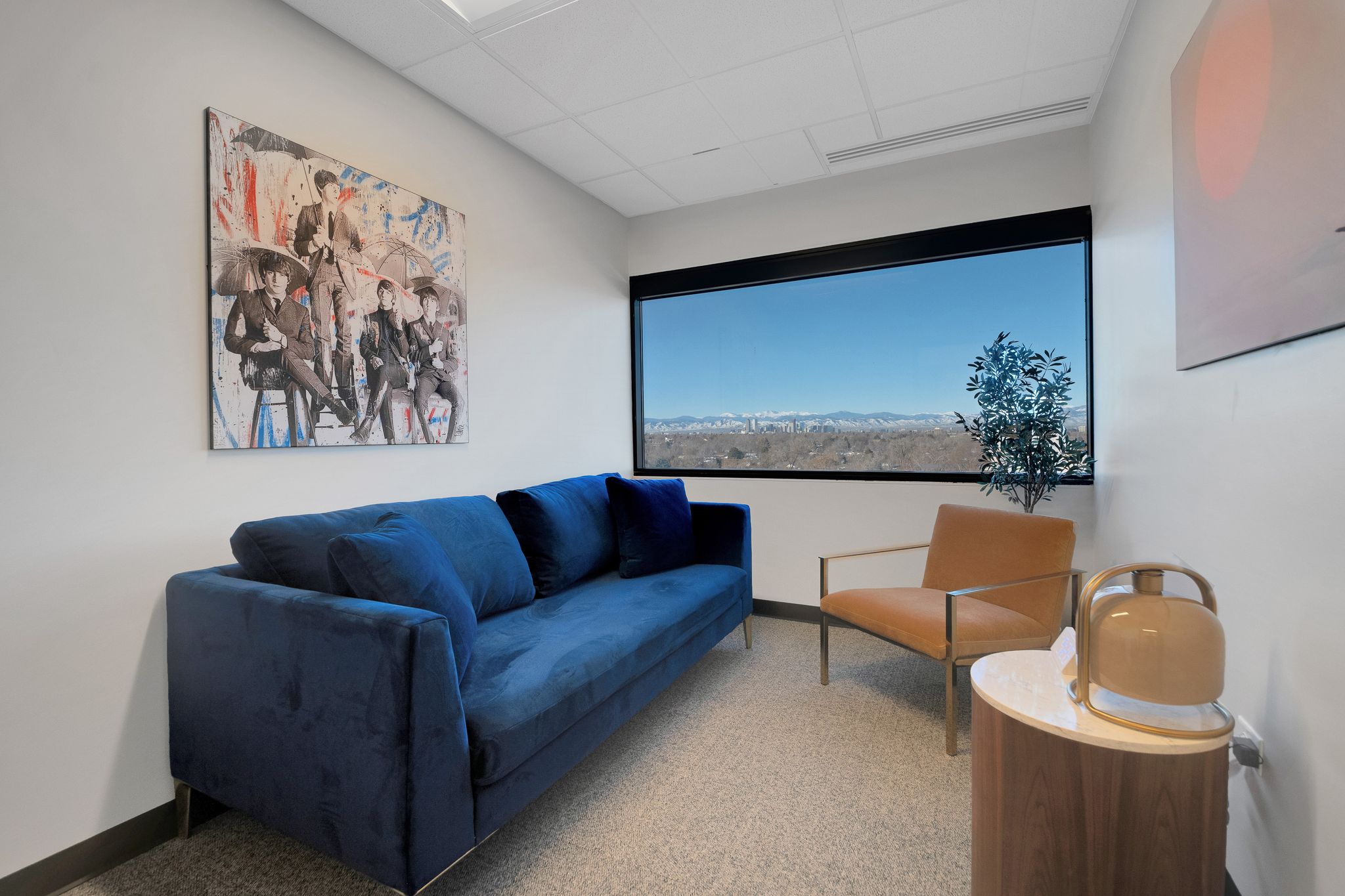 Individual meeting room with blue couch and chair